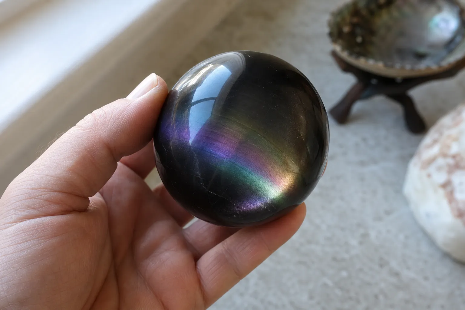 Polished obsidian showing a visible rainbow sheen under ordinary light