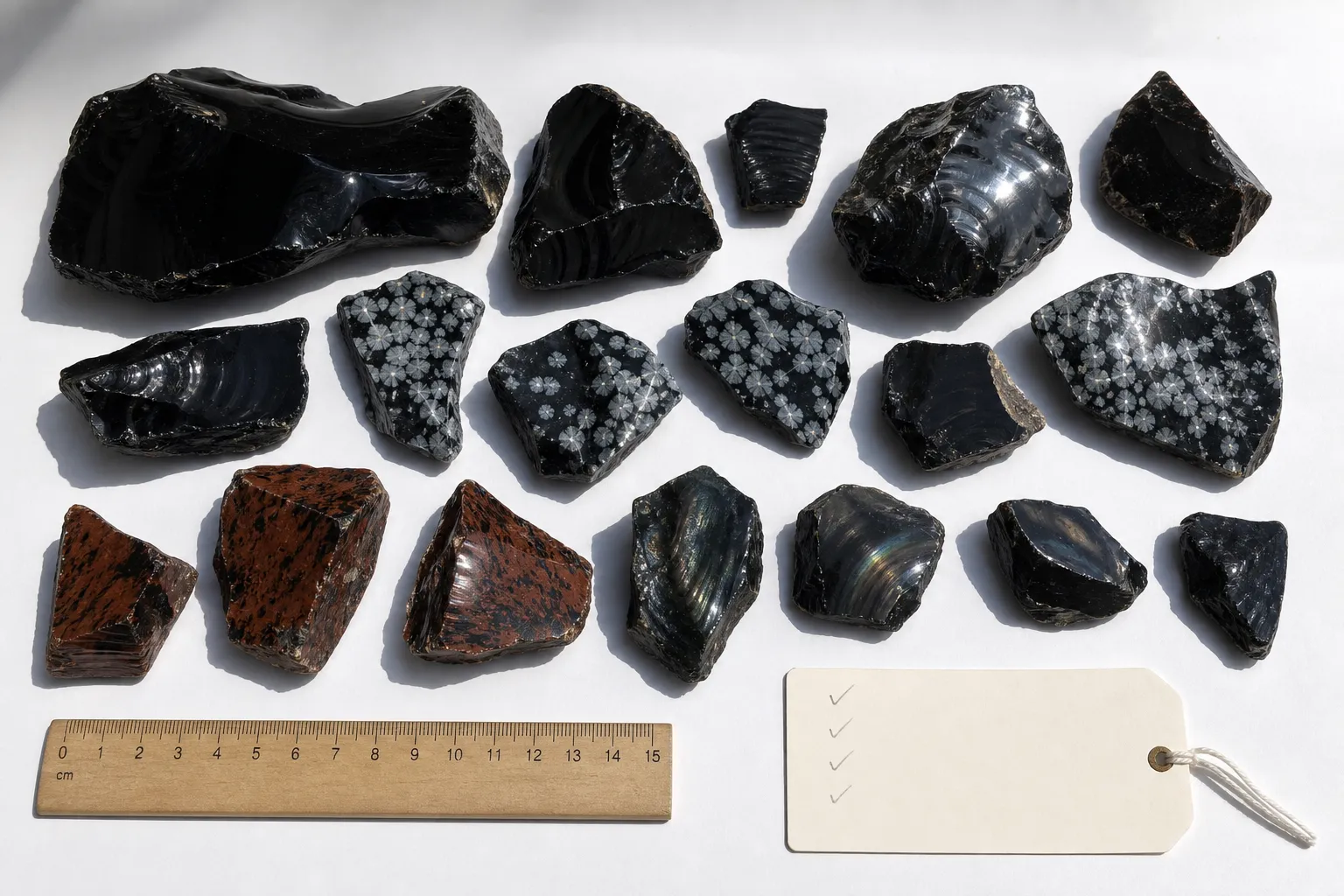 Mixed obsidian pieces spread out for a pre-purchase lot inspection