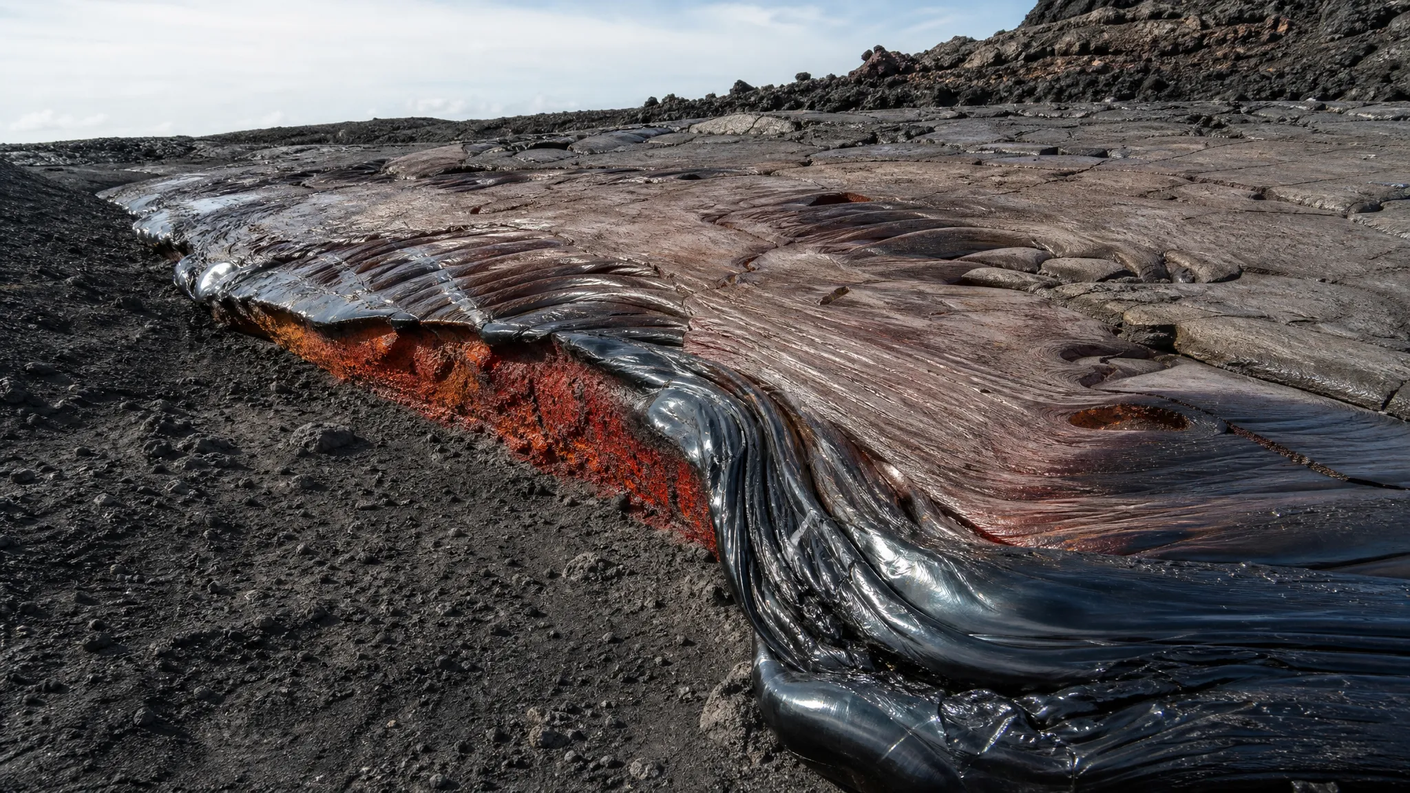Silica-rich rhyolitic lava shown as the parent material that can solidify into glassy obsidian