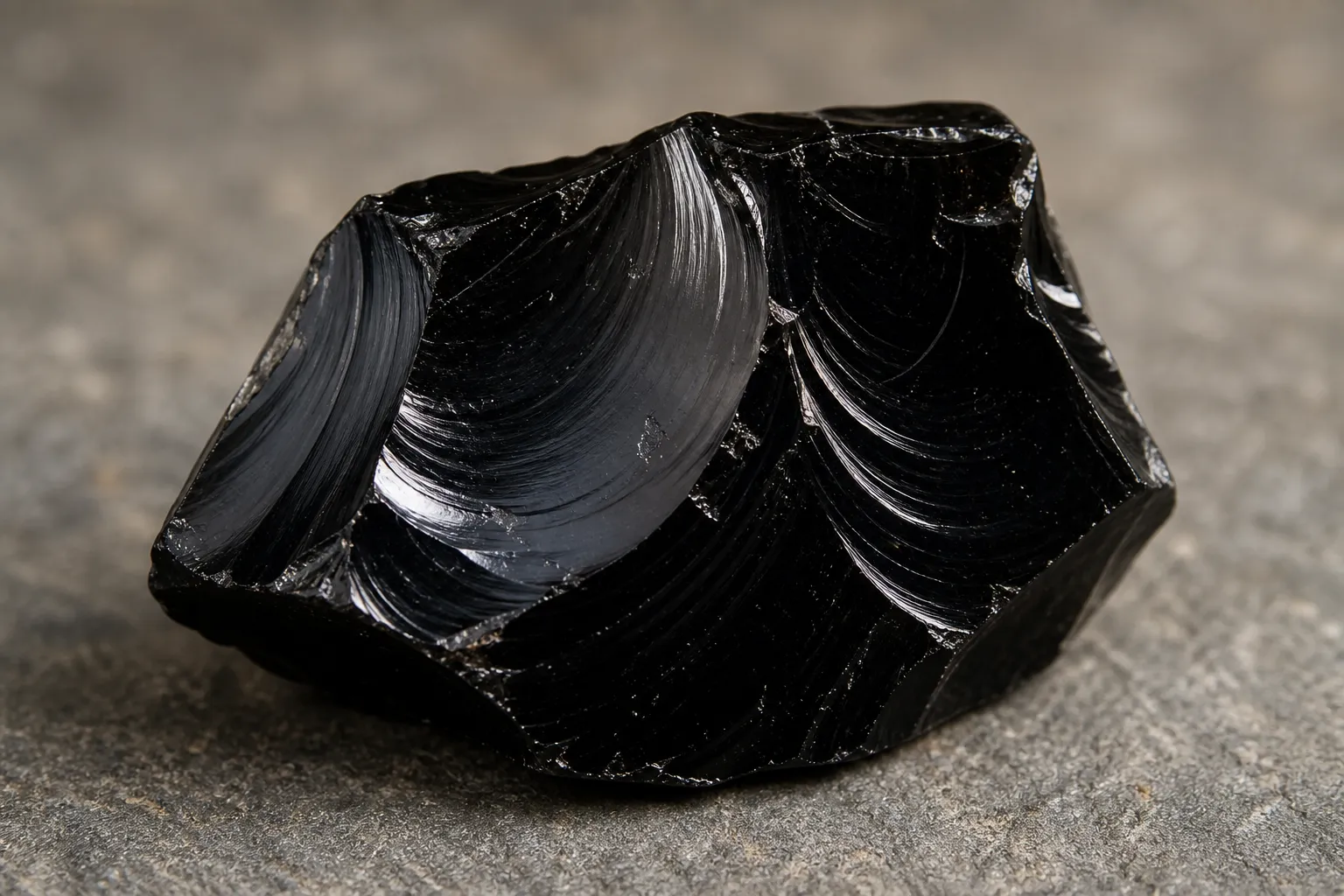Fresh broken obsidian showing a thin glassy edge formed by conchoidal fracture